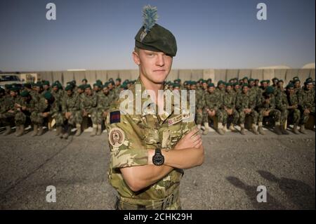 Lieutenant Pete Quentin, 27, serving with the London Regiment, a liaison officer working between the United States Marine Corps, the British Army and the Afghan National Army (ANA) during their training process stands in front of ANA soldiers prior to their graduation ceremony at Camp Leatherneck, next to the British base, Camp Bastion in Helmand Province, Afghanistan. PRESS ASSOCIATION Photo. Issue date: Thursday June 17, 2010. Camp Leatherneck is the base for 1 Marine Expeditionary Force, United States Marine Corps who lead the training of ANA soldiers. Photo credit should read: Sergeant Stock Photo