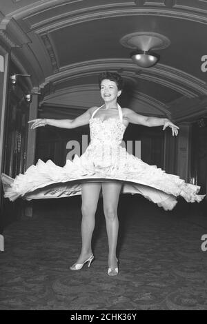 Swirling skirt goes with the honeyed notes of singer Eve Boswell pictured during her 8 hour rehearsals for the 1953 Royal Variety Performance, which is to be attended by Queen Elizabeth II at the London Coliseum tomorrow evening. Stock Photo