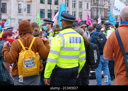 Metropolitan police controlling a demonstration by Extinction Rebellion in central London England UK