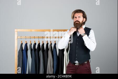 Man picking suit from personal wardrobe, male fashion concept. Stock Photo