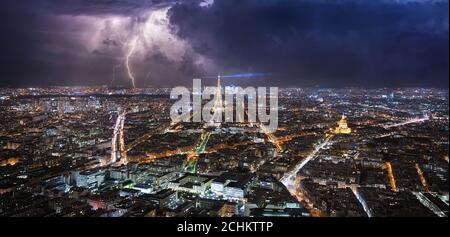 Stormy day in Paris with lightnings over the Eiffel Tower and Paris from Montparnasse tower at night Stock Photo