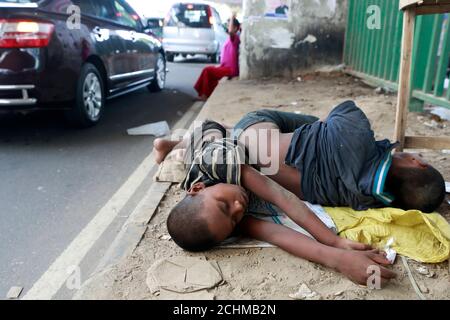 Dhaka, Bangladesh - September 13, 2020: Bangladeshi homeless children sleep on a roadside footpath in Dhaka, Bangladesh on September 13, 2020. Stock Photo