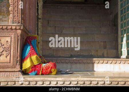 Jaipur, India: Sitting indian woman in a colorful sari Stock Photo