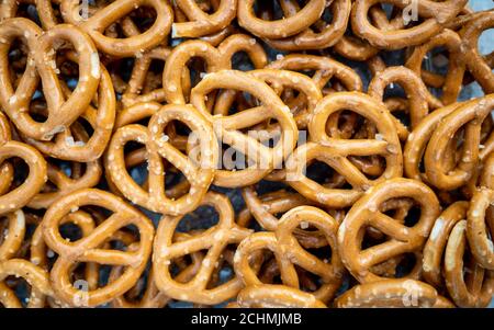 Mini salted pretzels. Full frame close detail abstract background texture of a bowl of mini salted pretzels. Stock Photo