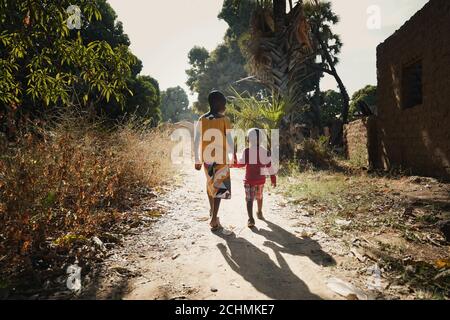 Sunset Picture of African Boys Brothers Walking Outdoors in a Typical Landscape Stock Photo