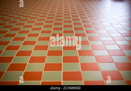 The tiles have a checkered pattern in brown and gray. Floor with two-tone antique ceramic tiles. Stock Photo