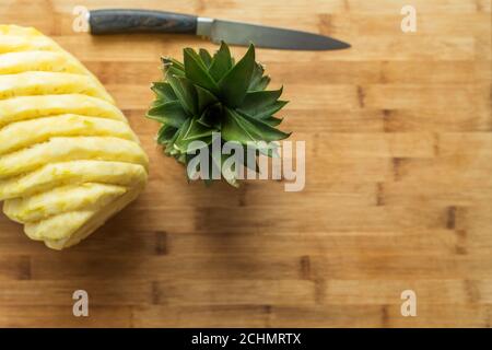 Ripe perfectly peeled pineapple, on a wooden background. Stock Photo