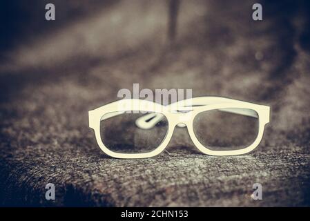 Female white sunglasses lie on a brown  background, summer. Stock Photo