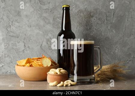 Lager beer mug and snacks on wooden table. Nuts, chips, dry fish Stock ...