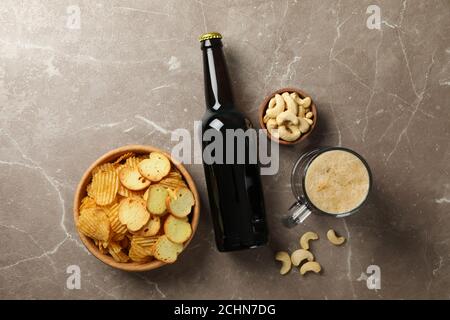 Beer and snacks on gray background, top view Stock Photo