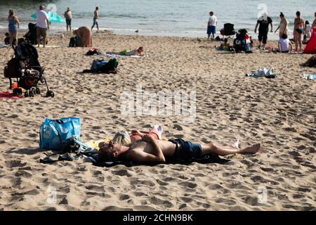 Tenby, Pembrokeshire, West Wales, UK. 14 September 2020.  UK weather:  People enjoy a walk along the coast today, with warm weather forecast for most of the week.  Credit: Andrew Bartlett/Alamy Live News. Stock Photo