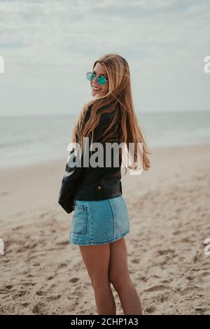 Beautiful blonde woman smiling and posing in the beach Stock Photo