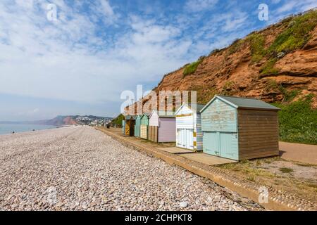 Typical seafront beach huts on the promenade at Budleigh Salterton, a small south coast town with a stony beach in East Devon, southwest England Stock Photo