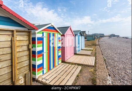 Typical seafront beach huts on the promenade at Budleigh Salterton, a small south coast town with a stony beach in East Devon, southwest England Stock Photo