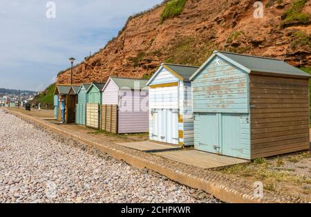 Typical seafront beach huts on the promenade at Budleigh Salterton, a small south coast town with a stony beach in East Devon, southwest England Stock Photo