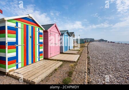 Typical seafront beach huts on the promenade at Budleigh Salterton, a small south coast town with a stony beach in East Devon, southwest England Stock Photo