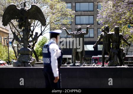 A police officer passes in front of a monument in Mexico City, Mexico March 26, 2019. REUTERS/Edgard Garrido