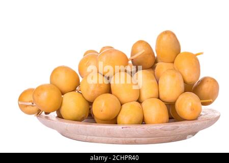 Dates or date palm in wood bowl isolated on white background Stock Photo