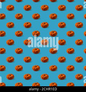 Seamless pattern with bright orange round textured pumpkins on blue background. High angle view on pumpkins. Stock Photo
