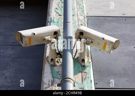 Two surveillance cameras pointing in opposite directions Stock Photo