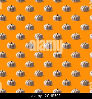 Seamless pattern with white round textured pumpkins on bright orange background. Side view on pumpkins. Stock Photo