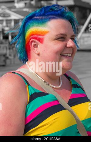 Zoe adds a splash of colour with rainbow coloured hair and dress at Pier Approach, Bournemouth, Dorset UK in September
