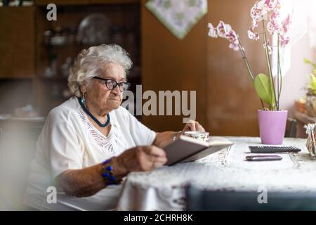 Portrait of an elderly woman at her home Stock Photo