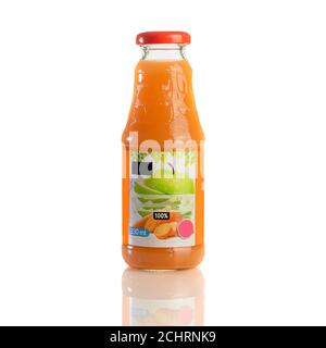 Juice in a glass bottle, bright colored drink on a white background isolated Stock Photo