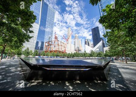 A view of Lower Manhattan from one of two reflecting pools at the National September 11 Memorial & Museum where the original One World Trade Center on Stock Photo