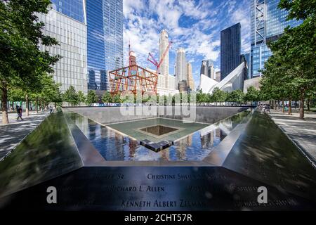 A view of Lower Manhattan from one of two reflecting pools at the National September 11 Memorial & Museum where the original One World Trade Center on Stock Photo