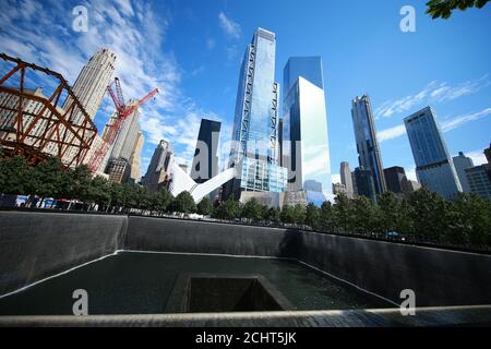 A view of Lower Manhattan from one of two reflecting pools at the National September 11 Memorial & Museum where the original One World Trade Center on Stock Photo