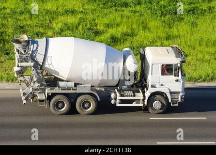 Concrete Mixer Truck rides the road highway Stock Photo