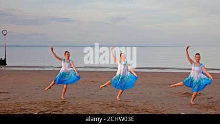 Portobello, Edinburgh, Scotland, UK. 14 September 2020. Pupils from Wren Dance School, Dalkeith rehearse their dance moves on the sandy beach with the Firth of Forth behind just before sunset, pictured left to right, Elizabel, Bethan, and Laris, temperature of 18 degees at 19.30. Credit: Arch White/ Alamy Live News. Stock Photo