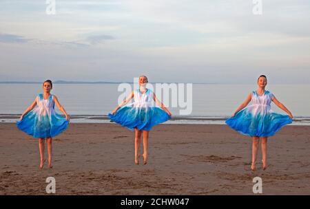 Portobello, Edinburgh, Scotland, UK. 14 September 2020. Pupils from Wren Dance School, Dalkeith rehearse their dance moves on the sandy beach with the Firth of Forth behind just before sunset, pictured left to right, Elizabel, Bethan, and Laris, temperature of 18 degees at 19.30. Credit: Arch White/ Alamy Live News. Stock Photo