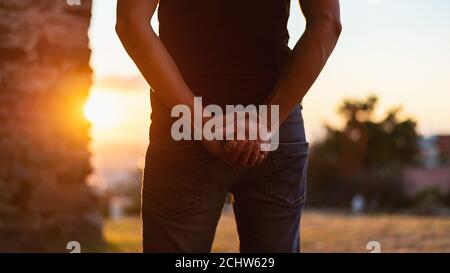 Man with clasped hands behind back. Stock Photo