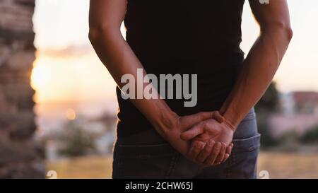 Man with clasped hands behind back. Stock Photo