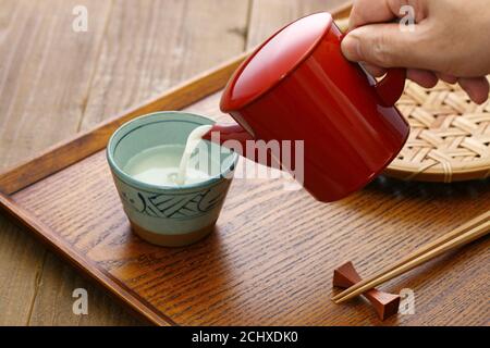 Sobayu is the hot water from boiling noodles in buckwheat noodle restaurants. After the soba(buckwheat) noodles are eaten, many people enjoy drinking. Stock Photo