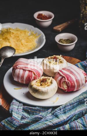 Bacon-wrapped button mushrooms stuffed with cheese Stock Photo