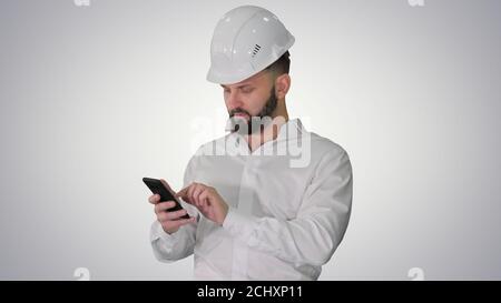 Smart engineer in white shirt and safety engineering hat using s Stock Photo