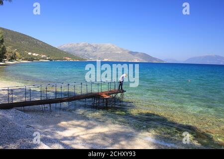 A man on the beach in Sami Village of Kefalonia island , Greece Stock Photo