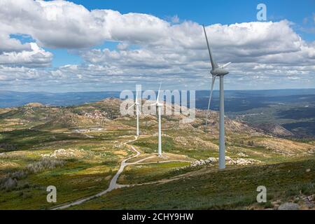 View of a wind turbines on top of mountains, blue sky as background in Portugal... Stock Photo