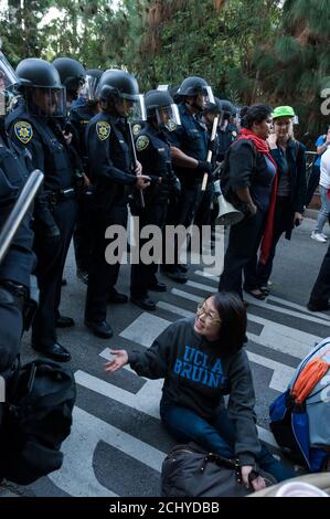 Los Angeles, CA, USA. 20th Nov, 2009. Students and police officers face off during a protest against a 32 percent tuition increase at the University of California Los Angeles. Stock Photo