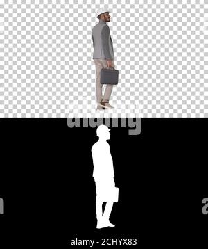 Engineer in helmet with briefcase walking, Alpha Channel Stock Photo