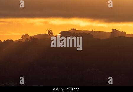 Sunset over coastal mountains near Dunedin, New Zealand, Southern Island, Dunedin Stock Photo