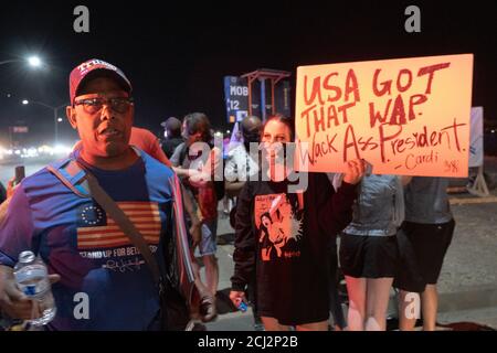 Henderson, NV, USA. 13th Sep, 2020. A supporter of President Donald Trump argues against the Black Live Matter movement as a protesters holds an Anti-Trump sign with a Cardi B quote next to him. Roughly 10 protesters showed up to President Donald Trump's rally in Henderson, NV chanting and holding signs outside the Xtreme Manufacturing building where Trump was speaking. Credit: Young G. Kim/Alamy Live News