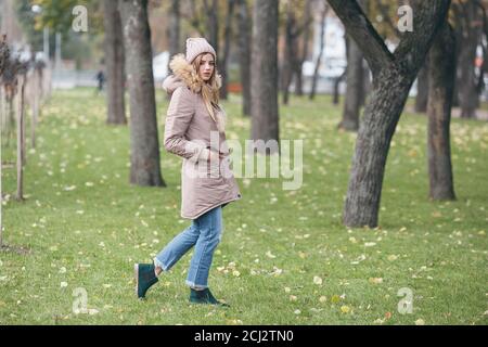 Young pretty woman walking in the autumn park Stock Photo