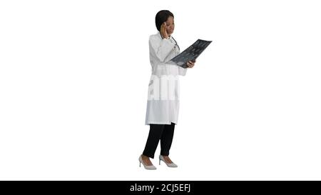 Female medical doctor reading x rays of patients brain on white Stock Photo