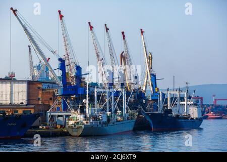 Summer, 2016 - Vladivostok, Russia - Vladivostok Sea Port. Commercial coasters are loading at the commercial port of Vladivostok. Stock Photo