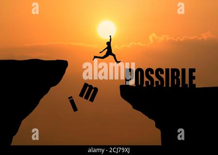 Man jumping over impossible or possible over cliff on sunset background,Business concept idea Stock Photo