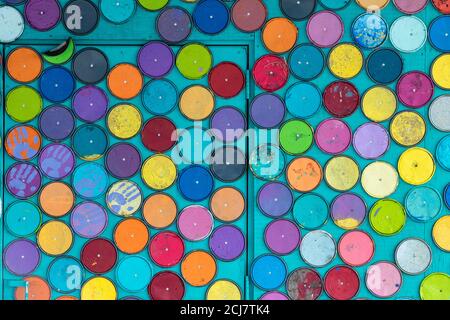 Whimsical display of paint can lids on wall, Sudbury, Ontario, Canada. Stock Photo